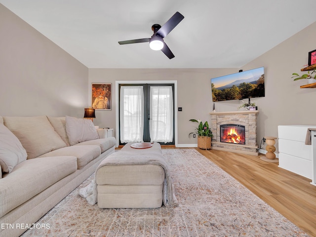 633 Vose Rd Unit G, Alcoa, TN 37701 - living area featuring wood finished floors, a ceiling fan, a stone fireplace, and baseboards