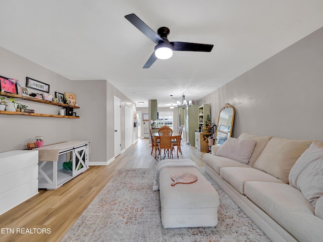 633 Vose Rd Unit G, Alcoa, TN 37701 - living room featuring a chandelier, a ceiling fan, light wood finished floors, and baseboards