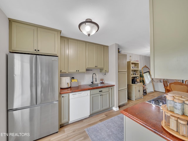 633 Vose Rd Unit G, Alcoa, TN 37701 - kitchen with freestanding refrigerator, white dishwasher, a sink, and light wood-type flooring