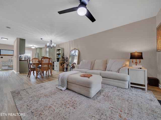 633 Vose Rd Unit G, Alcoa, TN 37701 - living room featuring a chandelier, ceiling fan, wood finished floors, and baseboards