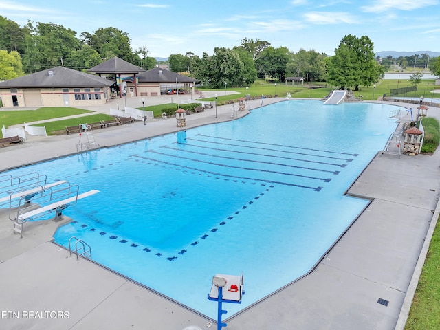 633 Vose Rd Unit G, Alcoa, TN 37701 - community pool with a patio, a water slide, view of scattered trees, and a mountain view