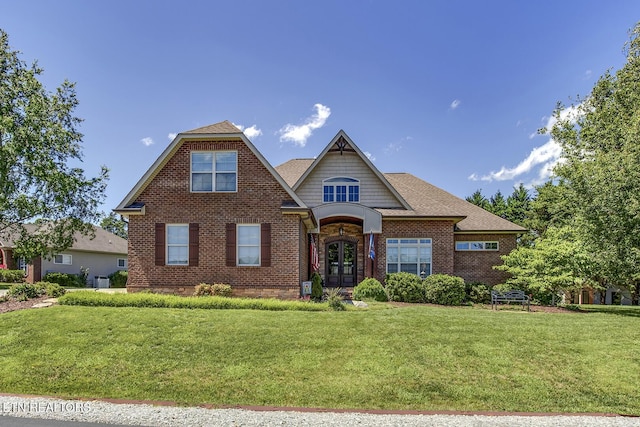 220 Tommotley Dr, Loudon, TN 37774 - view of front of house featuring brick siding, a front lawn, french doors, and a shingled roof