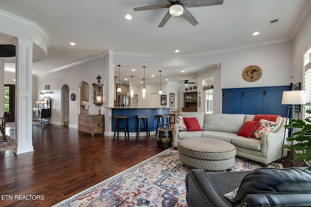 220 Tommotley Dr, Loudon, TN 37774 - living room featuring ceiling fan, dark wood-style flooring, ornate columns, arched walkways, and ornamental molding