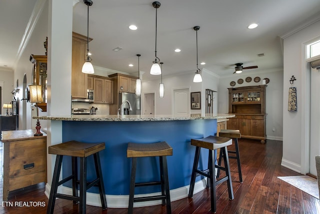 220 Tommotley Dr, Loudon, TN 37774 - kitchen with appliances with stainless steel finishes, ceiling fan, a breakfast bar area, light stone countertops, and crown molding