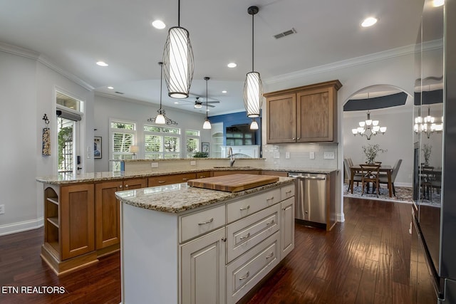 220 Tommotley Dr, Loudon, TN 37774 - kitchen featuring stainless steel dishwasher, a sink, brown cabinets, dark wood finished floors, and crown molding