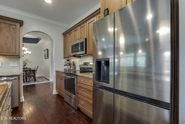 220 Tommotley Dr, Loudon, TN 37774 - kitchen featuring appliances with stainless steel finishes, backsplash, ornamental molding, arched walkways, and dark wood-style flooring