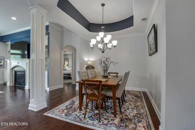 220 Tommotley Dr, Loudon, TN 37774 - dining room with arched walkways, ornamental molding, dark wood-style flooring, a chandelier, and a raised ceiling