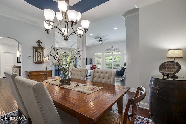 220 Tommotley Dr, Loudon, TN 37774 - dining area featuring ceiling fan, a chandelier, arched walkways, dark wood finished floors, and crown molding