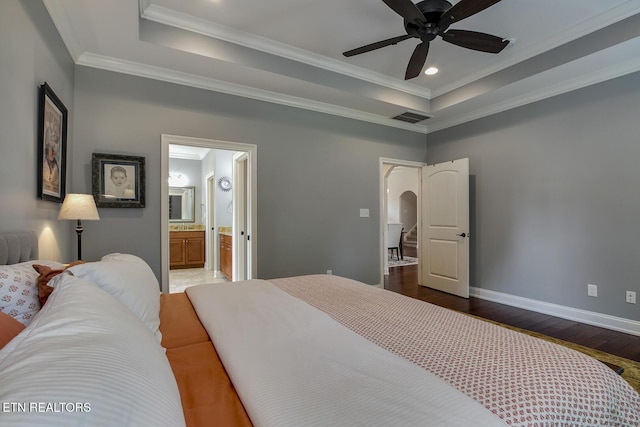 220 Tommotley Dr, Loudon, TN 37774 - bedroom featuring wood finished floors, a tray ceiling, baseboards, arched walkways, and ornamental molding