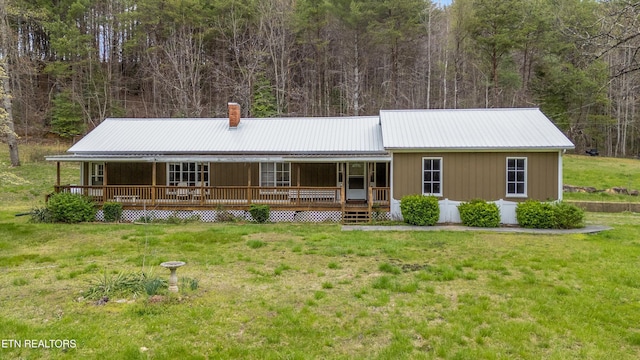 2009 Tellico Reliance Rd, Reliance, TN 37369 - view of front of property with a porch, a chimney, a front lawn, metal roof, and a wooded view