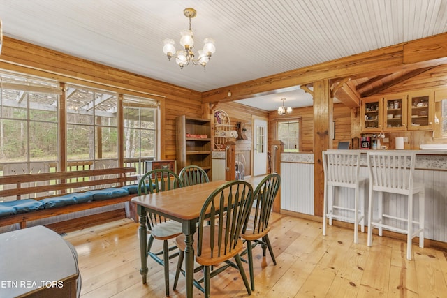 2009 Tellico Reliance Rd, Reliance, TN 37369 - dining area with a chandelier, plenty of natural light, hardwood / wood-style flooring, beamed ceiling, and wood walls