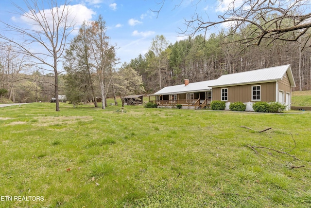 2009 Tellico Reliance Rd, Reliance, TN 37369 - view of grassy yard with a porch and an attached garage