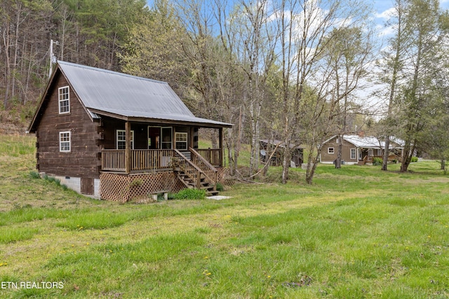 2009 Tellico Reliance Rd, Reliance, TN 37369 - view of front facade featuring a porch, metal roof, crawl space, log siding, and a front lawn