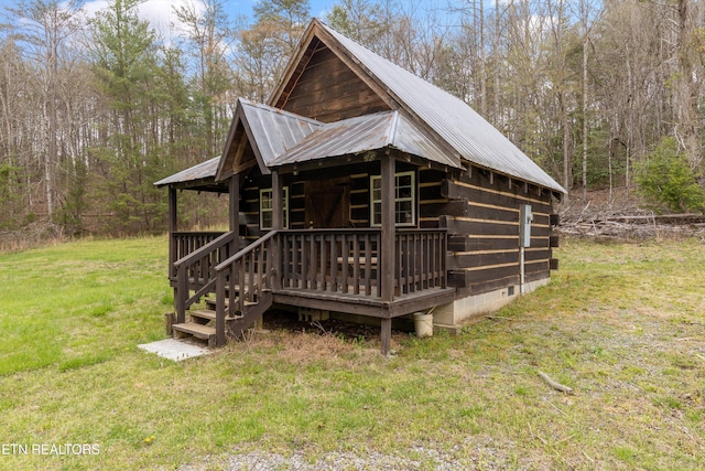 2009 Tellico Reliance Rd, Reliance, TN 37369 - view of home's exterior with metal roof, a yard, a wooden deck, crawl space, and a wooded view
