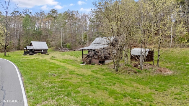 2009 Tellico Reliance Rd, Reliance, TN 37369 - view of grassy yard featuring stairway, an outbuilding, and a forest view