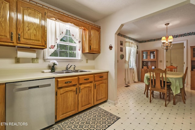 2162 Spruce Loop, Crossville, TN 38555 - kitchen with stainless steel dishwasher, a chandelier, a sink, brown cabinetry, and a textured ceiling