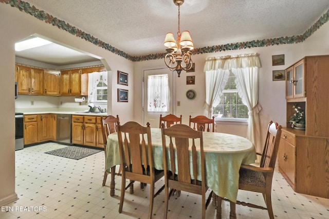 2162 Spruce Loop, Crossville, TN 38555 - dining area featuring light floors, a textured ceiling, a chandelier, and arched walkways