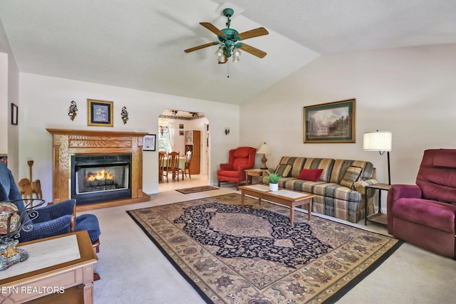 2162 Spruce Loop, Crossville, TN 38555 - living area with a ceiling fan, arched walkways, carpet flooring, vaulted ceiling, and a lit fireplace