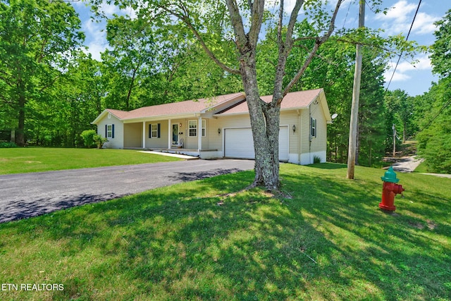 2162 Spruce Loop, Crossville, TN 38555 - ranch-style home featuring asphalt driveway, an attached garage, covered porch, and a front lawn
