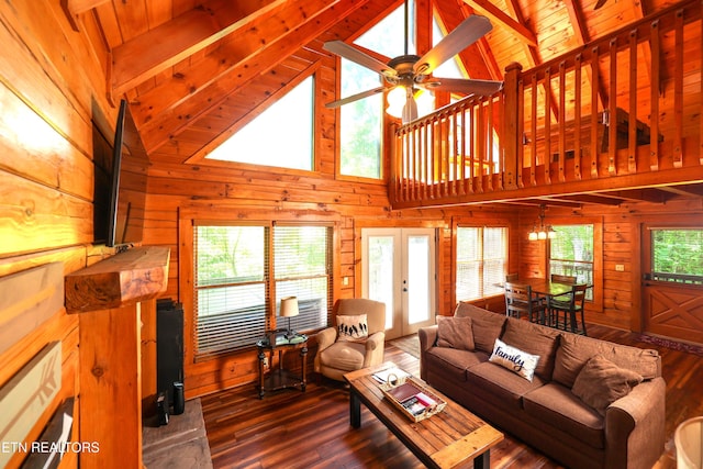556 Wildwood Forest Way, Sevierville, TN 37876 - living room with french doors, wood walls, dark wood-style flooring, ceiling fan, and high vaulted ceiling
