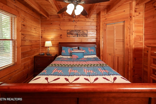 556 Wildwood Forest Way, Sevierville, TN 37876 - bedroom with wooden ceiling with exposed beams, wooden walls, and multiple windows