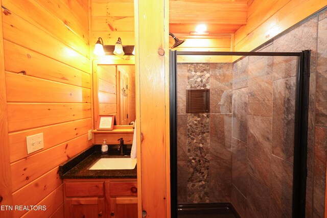 556 Wildwood Forest Way, Sevierville, TN 37876 - full bath featuring a shower stall, vanity, and wood walls