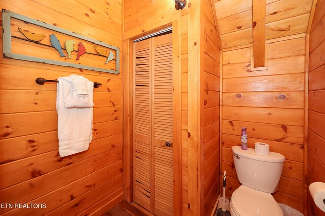 556 Wildwood Forest Way, Sevierville, TN 37876 - bathroom featuring toilet, wood walls, and a closet