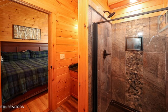 556 Wildwood Forest Way, Sevierville, TN 37876 - ensuite bathroom featuring a shower stall, a relaxing sauna, and wood finished floors