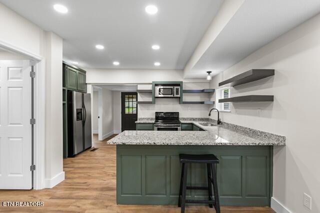 501 Dodson Ave, Englewood, TN 37329 - kitchen featuring appliances with stainless steel finishes, green cabinets, open shelves, a peninsula, and baseboards