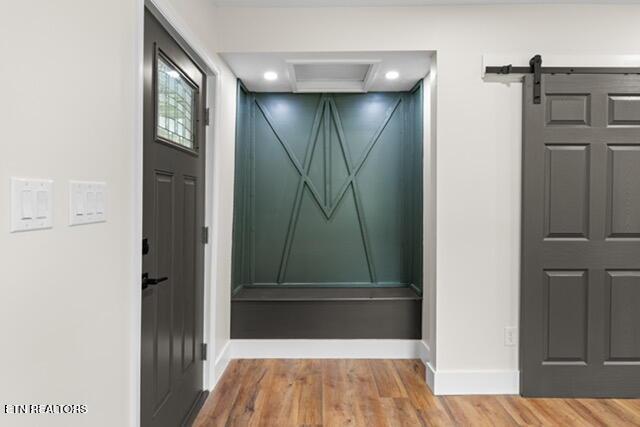 501 Dodson Ave, Englewood, TN 37329 - corridor featuring wood finished floors, baseboards, a barn door, a decorative wall, and recessed lighting