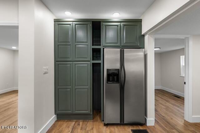 501 Dodson Ave, Englewood, TN 37329 - kitchen featuring stainless steel fridge with ice dispenser, green cabinets, baseboards, and light wood finished floors