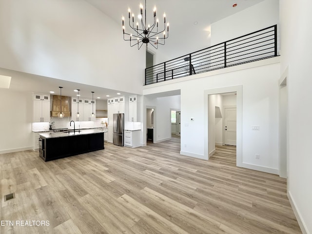 8349 Cliff Ridge Ct, Corryton, TN 37721 - kitchen with freestanding refrigerator, a sink, baseboards, light countertops, and light wood-type flooring