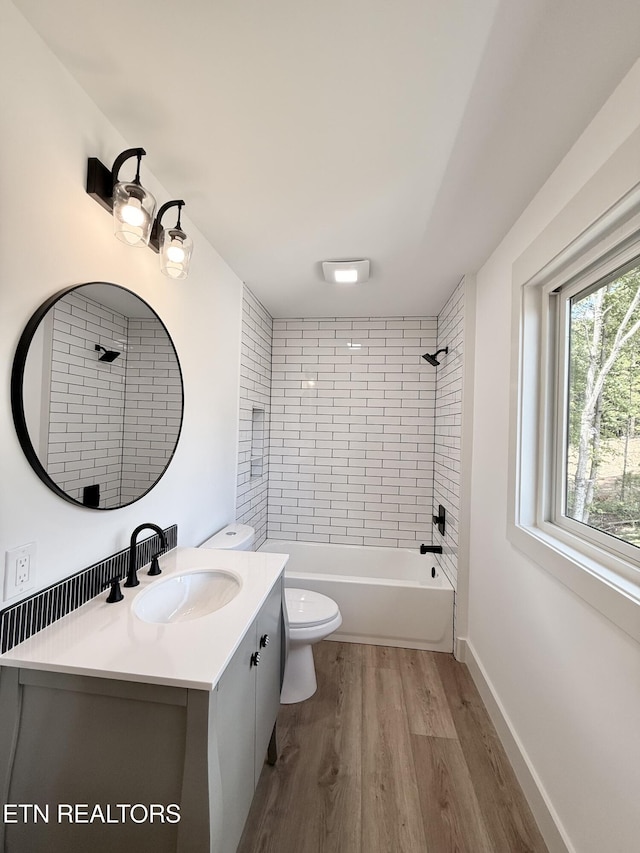 8349 Cliff Ridge Ct, Corryton, TN 37721 - full bathroom featuring vanity, toilet, wood finished floors, and shower / bath combination