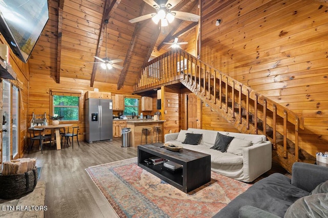 4372 Boogertown Rd Apt 3, Sevierville, TN 37876 - living area with wood walls, ceiling fan, light wood-style floors, stairs, and high vaulted ceiling