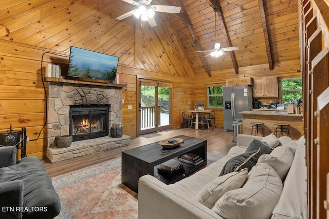 4372 Boogertown Rd Apt 3, Sevierville, TN 37876 - living room featuring a ceiling fan, wood ceiling with exposed beams, light wood-type flooring, wood walls, and high vaulted ceiling