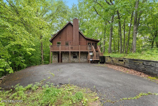 4372 Boogertown Rd Apt 2, Sevierville, TN 37876 - view of home's exterior featuring a chimney, stone siding, a wooden deck, and stairway