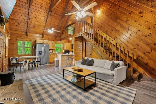 4372 Boogertown Rd Apt 2, Sevierville, TN 37876 - living room featuring high vaulted ceiling, a ceiling fan, healthy amount of natural light, wood walls, and light wood-type flooring