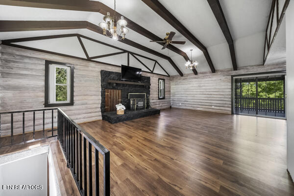 441 Morton Rd, Lafollette, TN 37766 - unfurnished living room with a chandelier, plenty of natural light, wood finished floors, and wooden walls