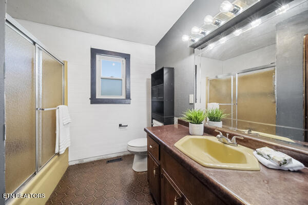 441 Morton Rd, Lafollette, TN 37766 - bathroom with vanity, toilet, tile patterned flooring, and bath / shower combo with glass door