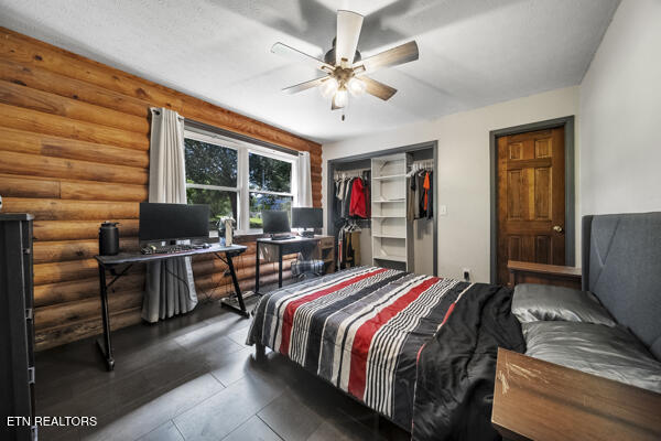 441 Morton Rd, Lafollette, TN 37766 - bedroom featuring log walls, an office area, a closet, and a ceiling fan