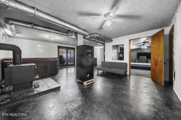 441 Morton Rd, Lafollette, TN 37766 - below grade area featuring a ceiling fan and a wood stove