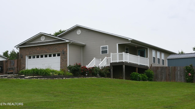 106 Alfred Mccammon Rd, Maryville, TN 37804 - rear view of property featuring a garage, brick siding, and a deck