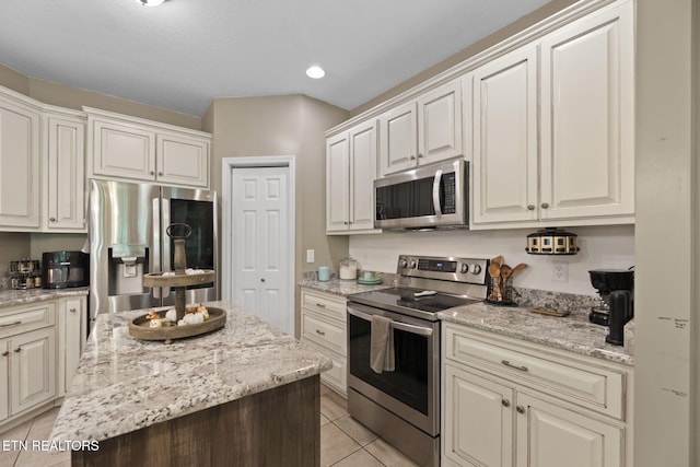 376 Old Holderford Rd, Kingston, TN 37763 - kitchen with stainless steel appliances, light tile patterned floors, light stone countertops, and recessed lighting