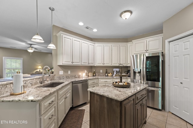 376 Old Holderford Rd, Kingston, TN 37763 - kitchen featuring appliances with stainless steel finishes, a sink, light tile patterned floors, a peninsula, and a ceiling fan