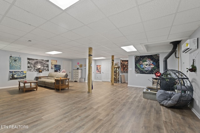376 Old Holderford Rd, Kingston, TN 37763 - living area with baseboards, a wall mounted air conditioner, wood finished floors, and a drop ceiling