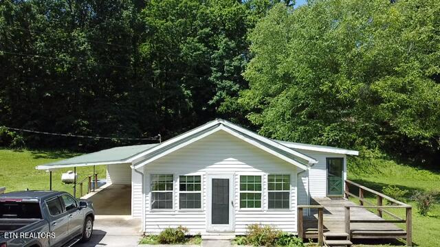 547 Knob Rd, Vonore, TN 37885 - view of front of house featuring concrete driveway, a deck, and a carport