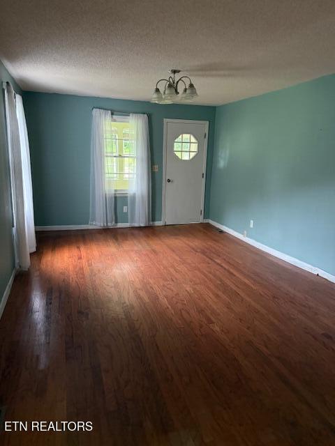 547 Knob Rd, Vonore, TN 37885 - entryway with wood finished floors, baseboards, a chandelier, and a textured ceiling