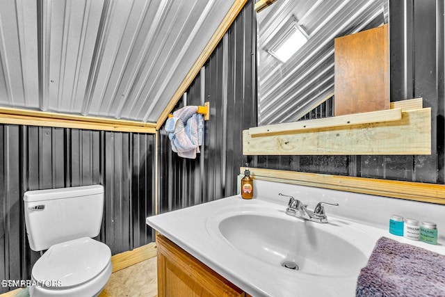 1513 Tyler Way, Sevierville, TN 37876 - bathroom with vanity, toilet, lofted ceiling, and wooden walls