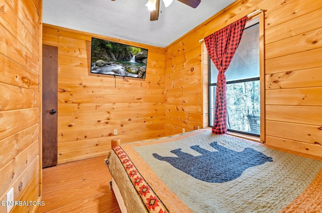 1513 Tyler Way, Sevierville, TN 37876 - unfurnished bedroom with wood walls, wood finished floors, and ceiling fan