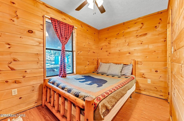 1513 Tyler Way, Sevierville, TN 37876 - bedroom with wood finished floors, wooden walls, and ceiling fan